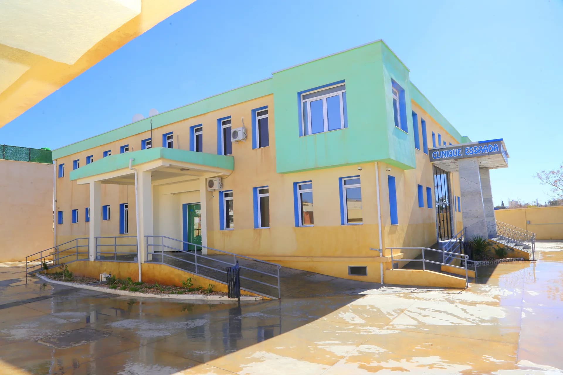 Façade extérieure de la Clinique ESSAADA, bâtiment de deux étages avec rampe d'accès, à Sidi Bel Abbès